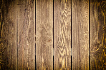 Empty wooden background with vignette for layouts. The fence of the old boards. Photo wood texture.