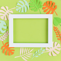 white frame on a green background with colored leaves