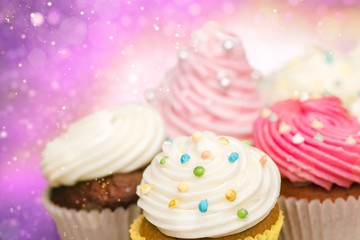 Tasty Colorful cupcakes on background
