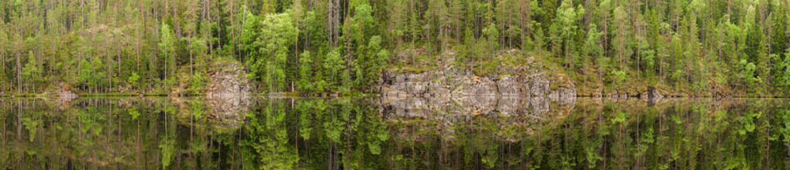 Fototapeta na wymiar Landscape reflection from forest lake in Finland