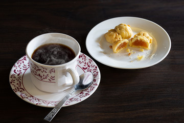 English tea in cup and fruits pie in plate on dark background