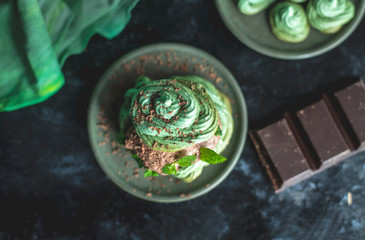 mint meringue with chocolate cream on a dark, moody background