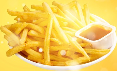 Fresh fried french fries with ketchup on wooden background
