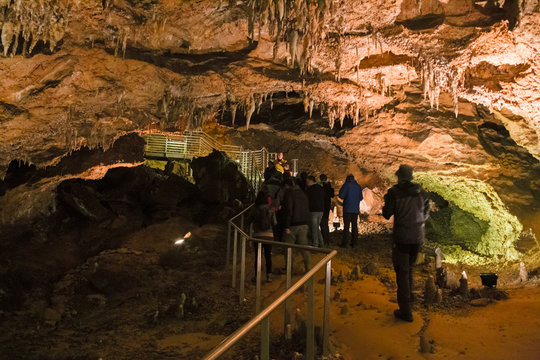 LEVIGLIANI, ITALY - JUNE 05, 2016: Some visitors admire the stalactites of the Antro del Monte Corchia cave in the Apuan Alps in Italy.