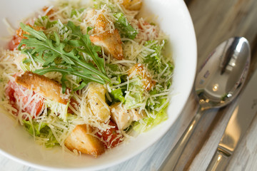 Caesar salad with souce on a table