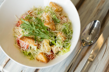 Caesar salad with souce on a table