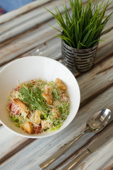 Caesar salad with souce on a table