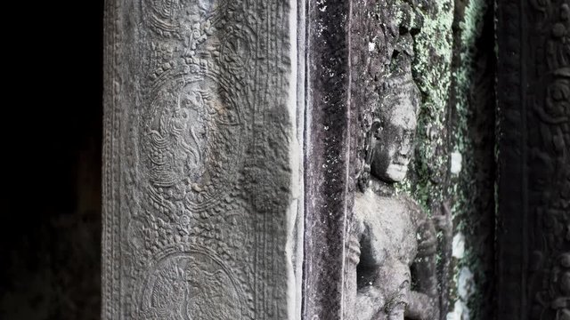 View from toes to head of corrupted apsara bas-relief, a female spirit of the clouds and waters in Hindu and Buddhist culture. Bayon temple, Cambodia