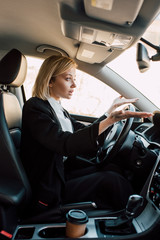 upset blonde young woman gesturing while sitting in car