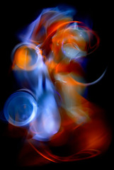 The abstract image painted by moving light and moving objects on a black background. Color abstraction.
