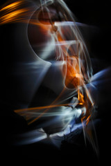 The abstract image painted by moving light and moving objects on a black background. Color abstraction.