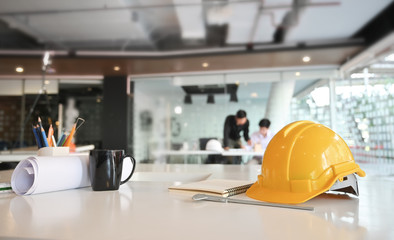 Engineer helmet and drawing equipment. Architectural Office desk construction project.