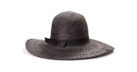 Pretty straw hat with ribbon and bow on white background. Beach hat top view isolated