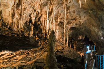 A footbridge allows you to visit the beautiful rock formations of the Antro del Monte Corchia cave in the Apuan Alps in Italy.