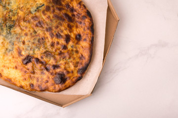 Khachapuri Megrelian with spinach and parsley. Pita bread with cheese