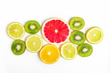 citrus slices - kiwi, oranges and grapefruits on white background. Fruits backdrop