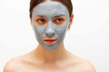 pretty young girl  useful clay mask to the face