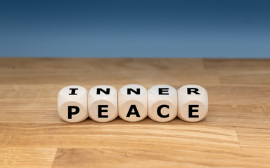 Dice form the words "INNER PEACE".