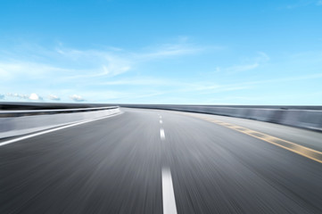 Motion-blurred highway in dusk clouds