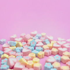 Fototapeta na wymiar Close-up colorful pastel sweet color of marshmallows on pink background with copy space
