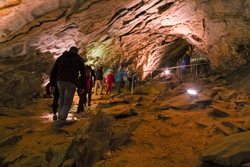 LEVIGLIANI, ITALY - JUNE 05, 2016: Some visitors admire the stalactites of the Antro del Monte...
