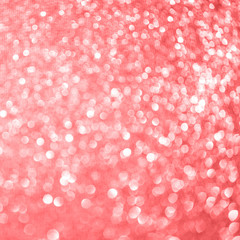 Blurred bokeh light red pink coral party background, Christmas and New Year holidays background. Party concept. Festive holiday card bright backdrop. Defocused. Flat lay, top view, copy space.