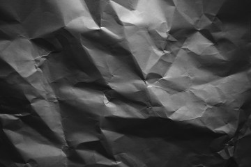 Crumpled gray paper with vignette background texture