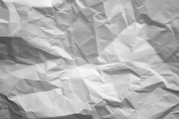 Obraz premium Crumpled gray paper with vignette background texture