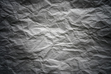 Crumpled gray paper with vignette background texture