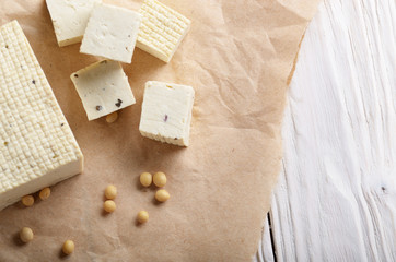 Soy Bean curd tofu on parchment paper Non-dairy alternative substitute for cheese