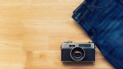 Jeans and retro cameras Lay on the wooden floor