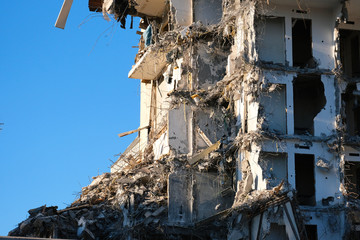 Demolished destructed building ruins. Demolition site in european city. Ruined house on a bright...