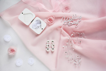 wedding wooden words, decorative fabric flowers, bridal jewelry on the pink cloth - wedding decoration content