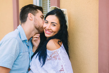 beautiful, young people kiss, girl is happy, beautiful warm evening, woman in a hat