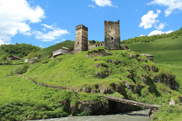Old stone Towers in the Caucasus in Georgia and a wood bridge in Ushguli