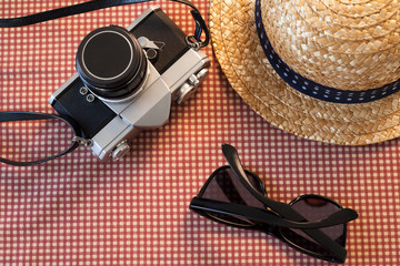Camera sunglasses and a hat for travel