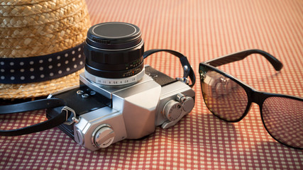 Camera sunglasses and a hat for travel