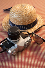 Camera sunglasses and a hat for travel