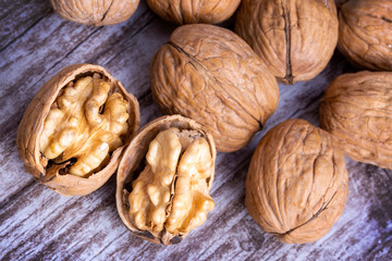 Walnuts on dark vintage table, Walnuts kernels in wooden bowl. Walnut healthy food