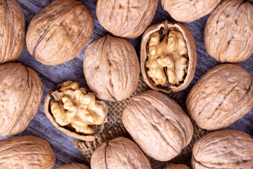Walnuts on dark vintage table, Walnuts kernels in wooden bowl. Walnut healthy food