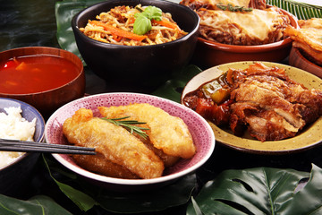 Assorted Chinese food set. Chinese noodles, fried rice, peking duck, dim sum, spring rolls. Famous Chinese cuisine dishes on table. Chinese restaurant
