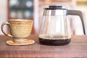 Close up of coffee drip brewing gadgets on wooden bar counter, background 