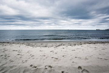 Empty beach background of free space and ocean landscape with dark sky 