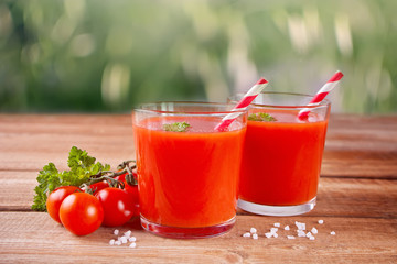 Tomato juice with parsley and salt on the wooden table