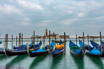 Fototapeta na wymiar Gondolas moored in Piazza San Marco with San Giorgio Maggiore church in the background