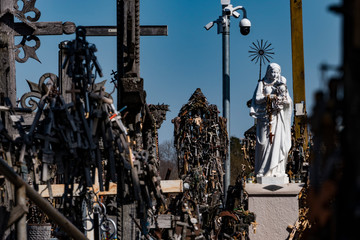 Fototapeta na wymiar Siauliai, Lithuania Crosses and crucifixes at the Hill of Crosses, or, Kryžių kalnas, a pilgrimage site for Catholics and is a collection of 100,000 crosses.