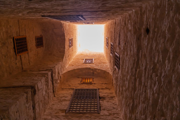 Bottom view inside tower of citadel of Qaitbay fortress and its main entrance yard. Antique landmark in Alexandria, Egypt.