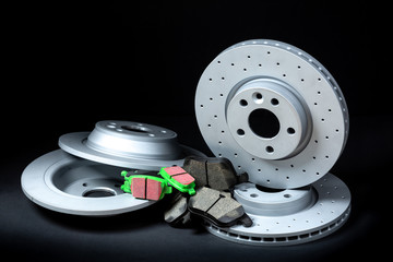 Set of sport brakes for the car. Brake discs with pads. Black background.