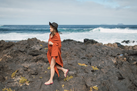 Woman with towel near sea