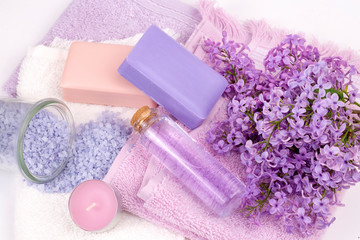 Fototapeta na wymiar Lilac nature cosmetics, handmade preparation of essential oils, perfume, creams, soaps from fresh and lilac flowers